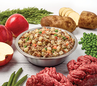 jffd beef and potato recipe presented in a bowl with raw, fresh ingredients are displayed around the bowl